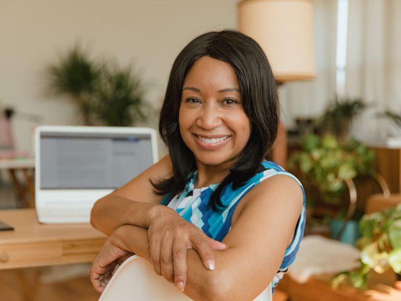 A smiling small business owner at her desk.